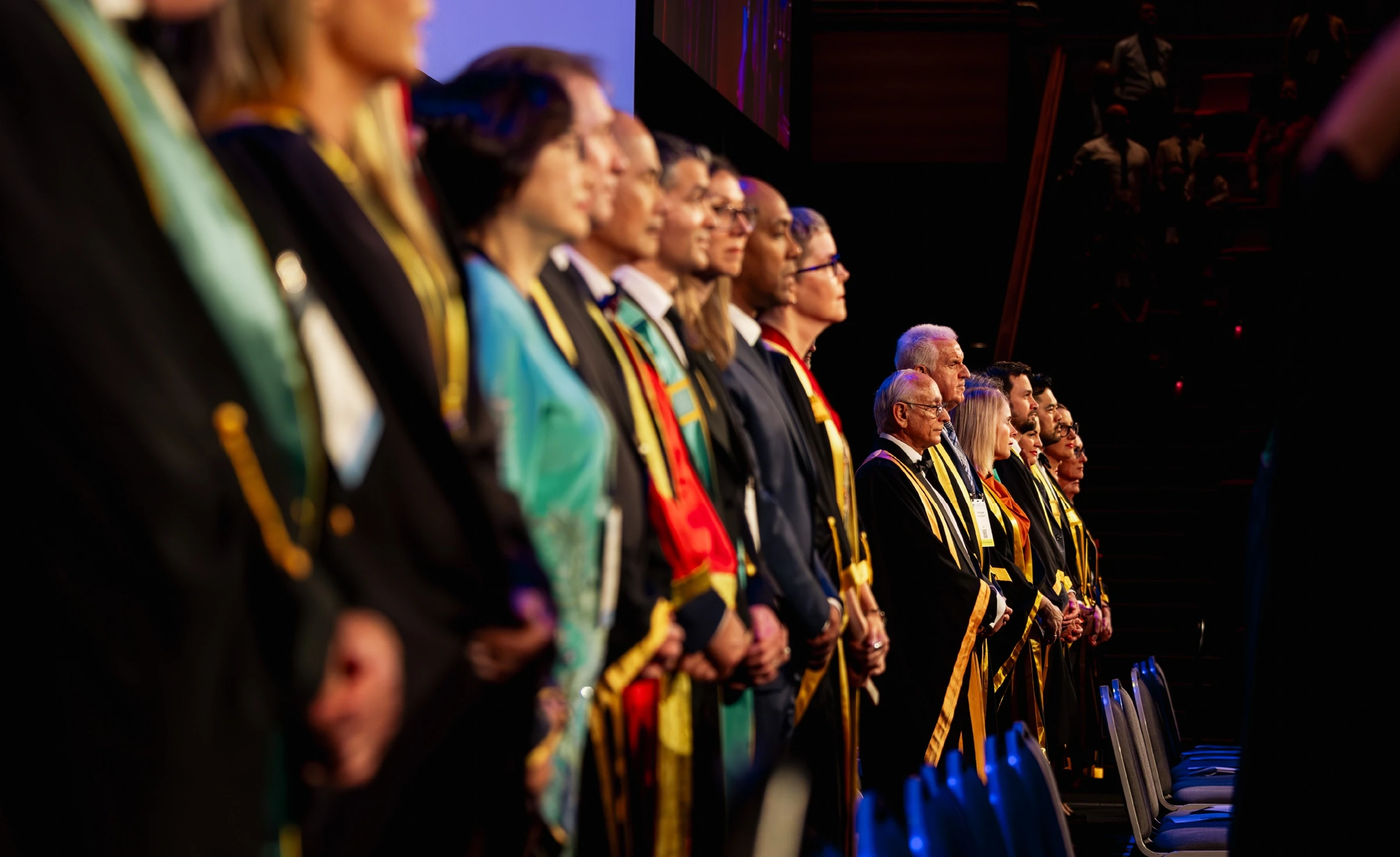 ANZCA and FPM fellows on stage in their gowns