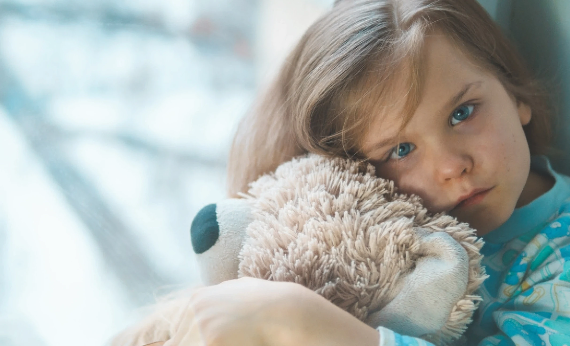 Child hugging a teddy bear