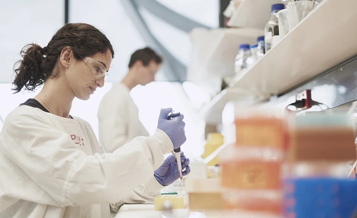 An anaesthetist researcher in a laboratory carefully pipetting a sample, representing the VAPOR-C trial's focus on precision in clinical research.