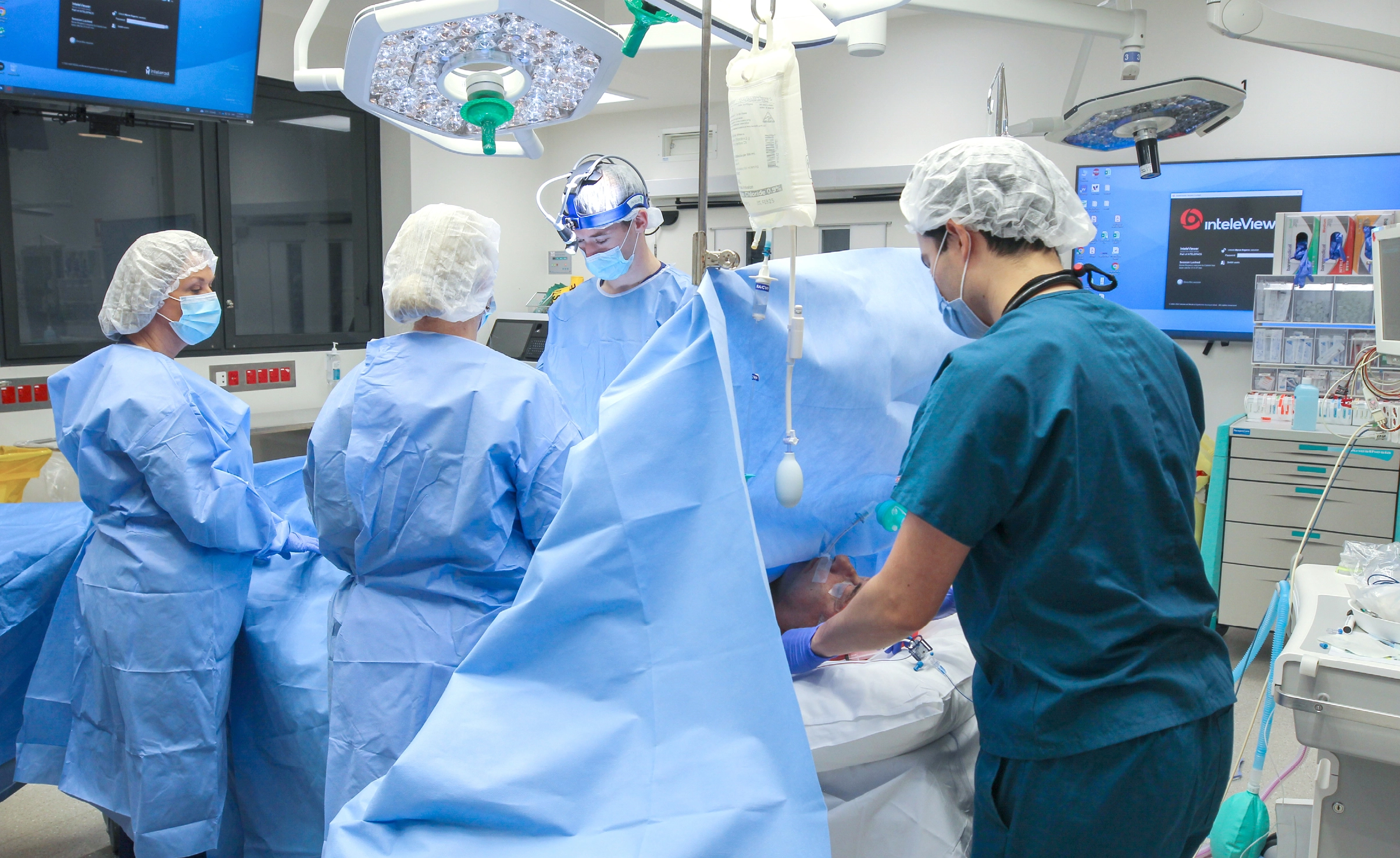 Doctors operating on patient in theatre