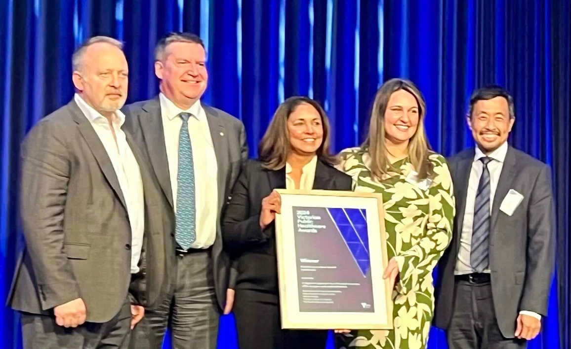 Group of people with a framed certificate