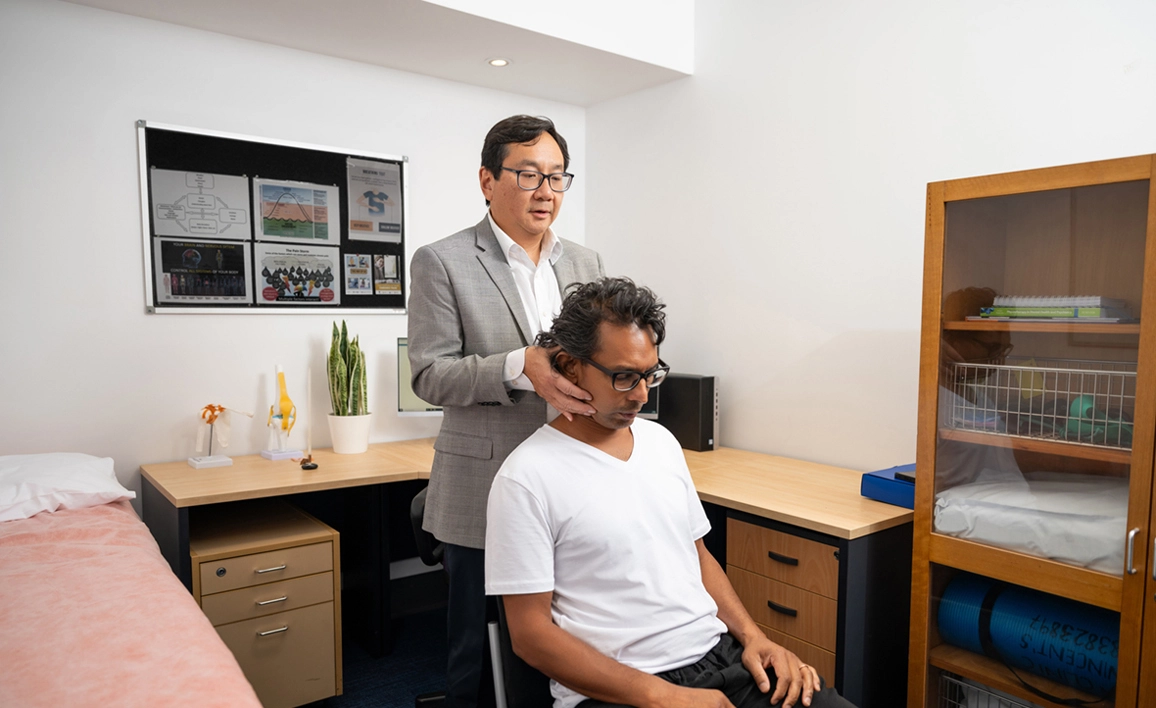 Doctor adjusting patient's neck 