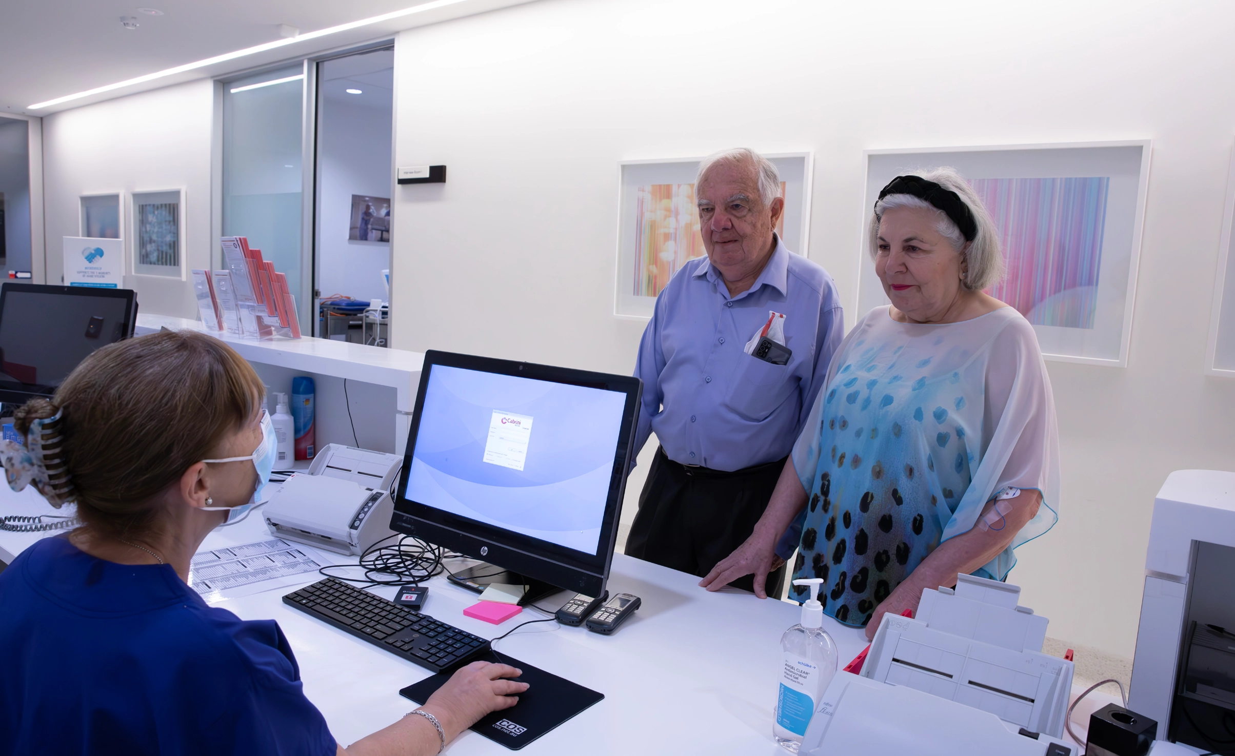 Patients talking to medical receptionist